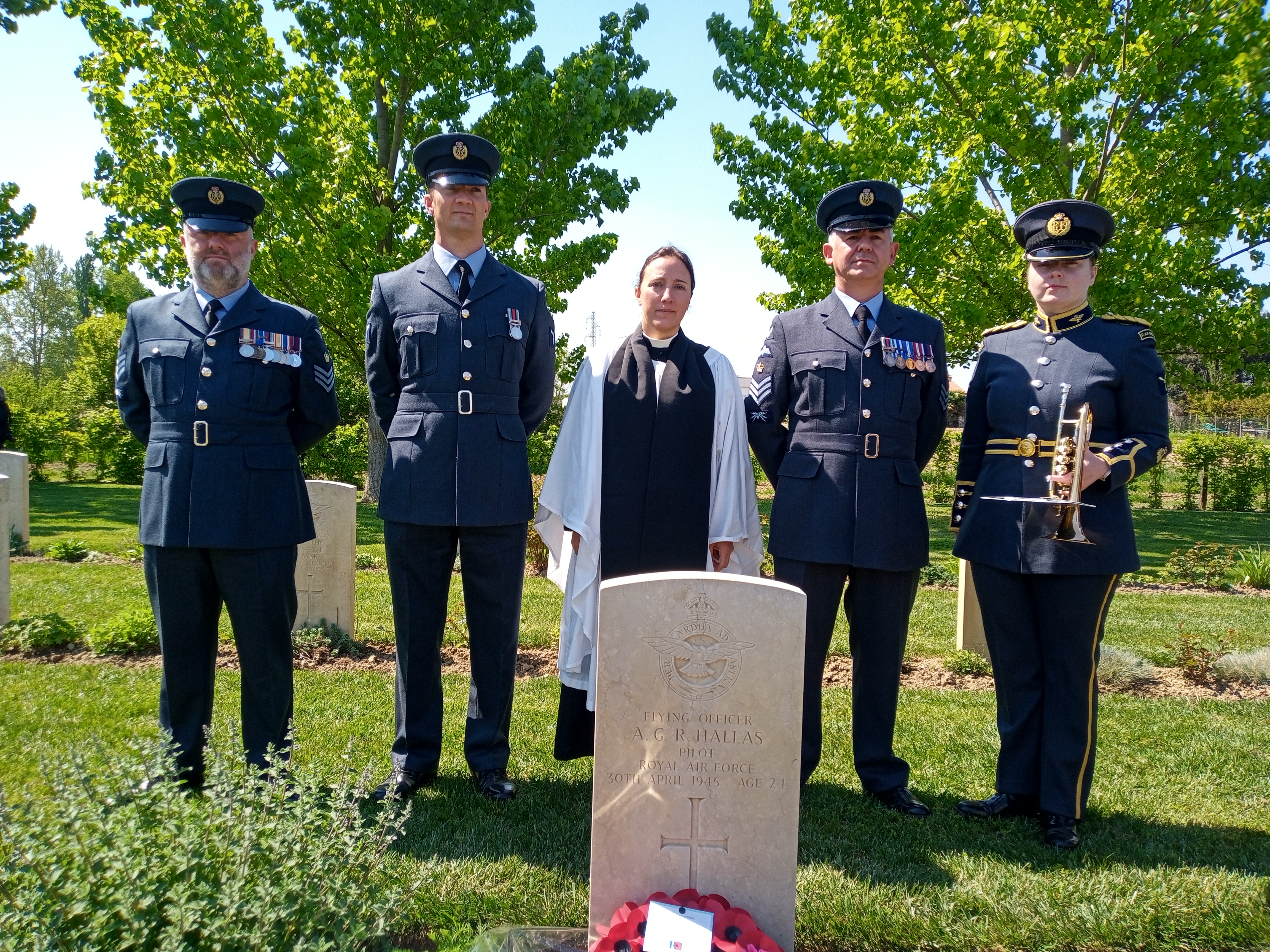 Personnel and Reverend stand by memorial.